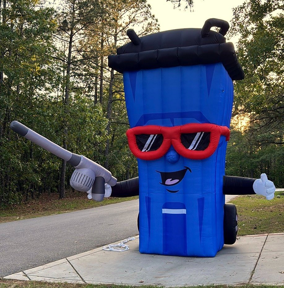 Our 15-foot inflatable blue trash can mascot with red sunglasses